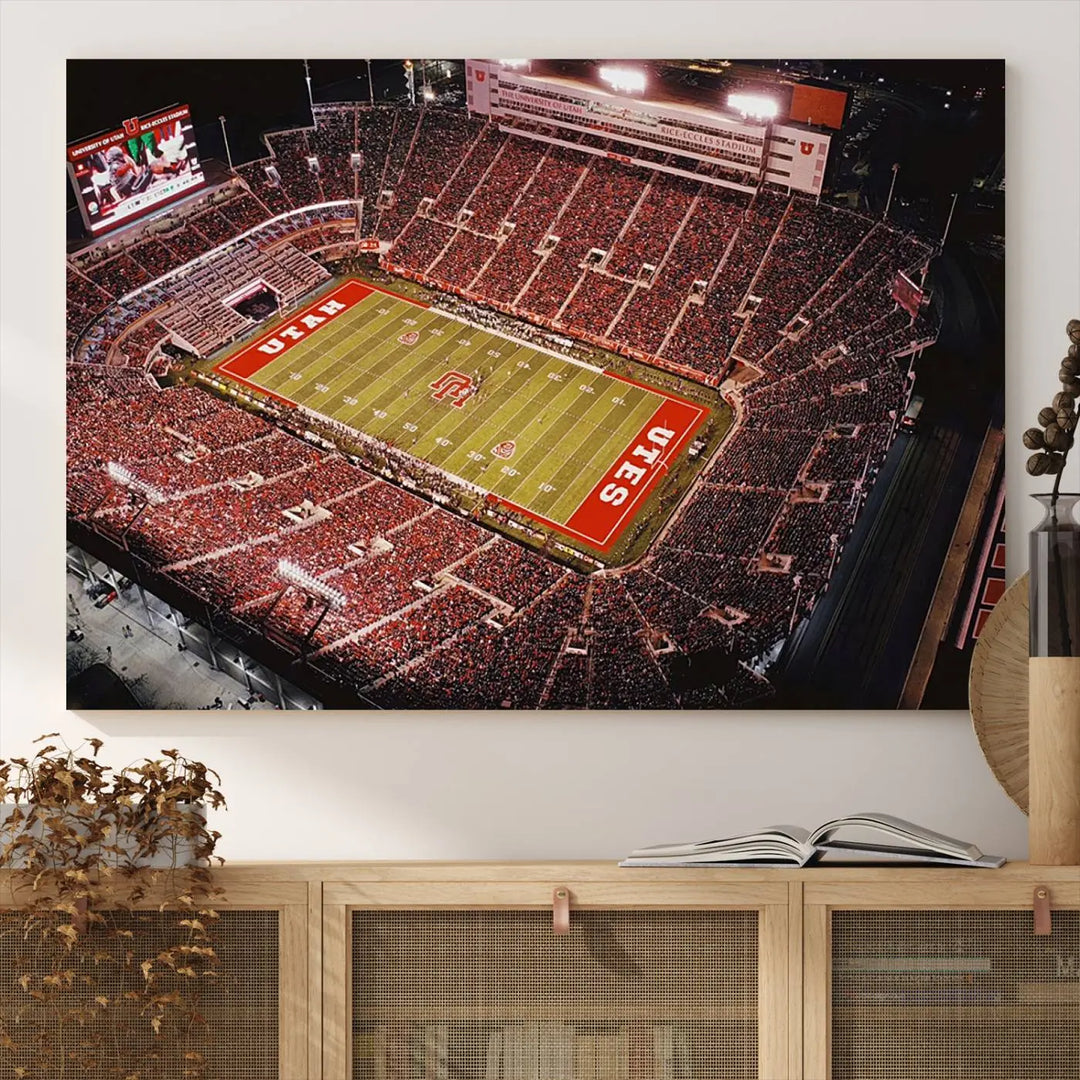 The modern living room is adorned with a Utah Utes Football Team Print - Salt Lake City Rice-Eccles Stadium Wall Art Canvas Print, depicting a packed football stadium.