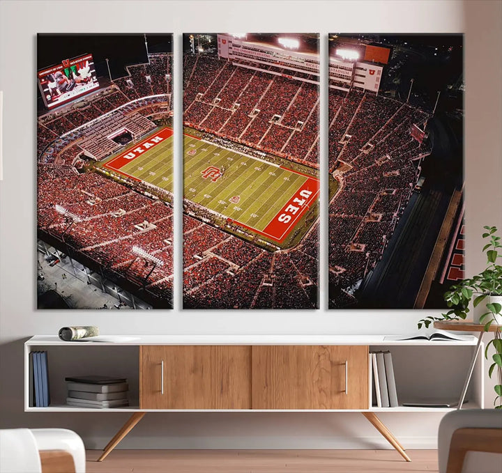 The modern living room is adorned with a Utah Utes Football Team Print - Salt Lake City Rice-Eccles Stadium Wall Art Canvas Print, depicting a packed football stadium.