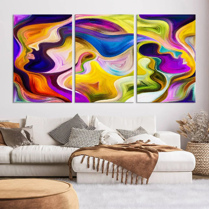 The wall above features the Vibrant Colors Human Figures Wall Art Canvas Print. Each piece showcases abstract multicolored face silhouettes on museum-quality canvas, enhancing both its vibrancy and longevity.