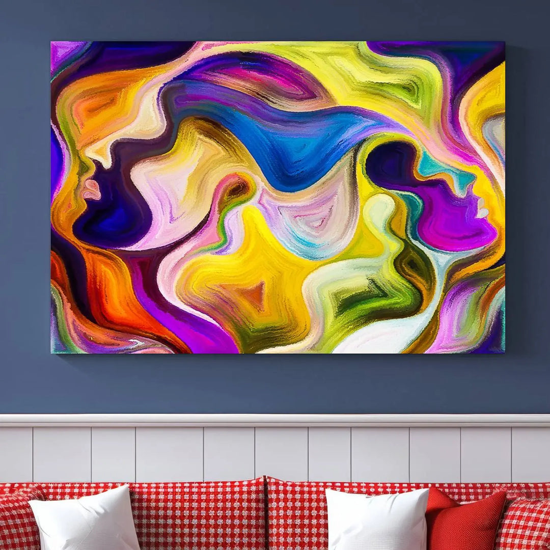 The wall above features the Vibrant Colors Human Figures Wall Art Canvas Print. Each piece showcases abstract multicolored face silhouettes on museum-quality canvas, enhancing both its vibrancy and longevity.