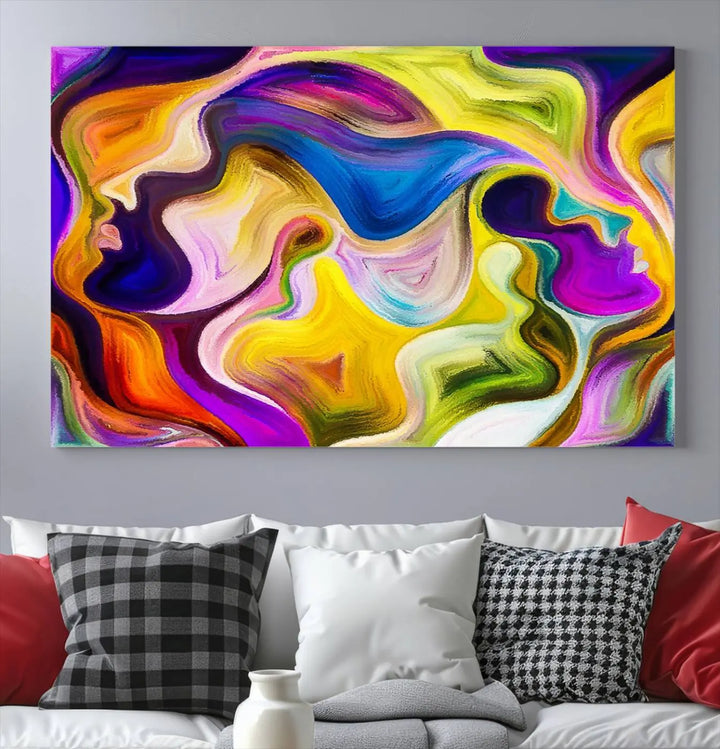 The wall above features the Vibrant Colors Human Figures Wall Art Canvas Print. Each piece showcases abstract multicolored face silhouettes on museum-quality canvas, enhancing both its vibrancy and longevity.