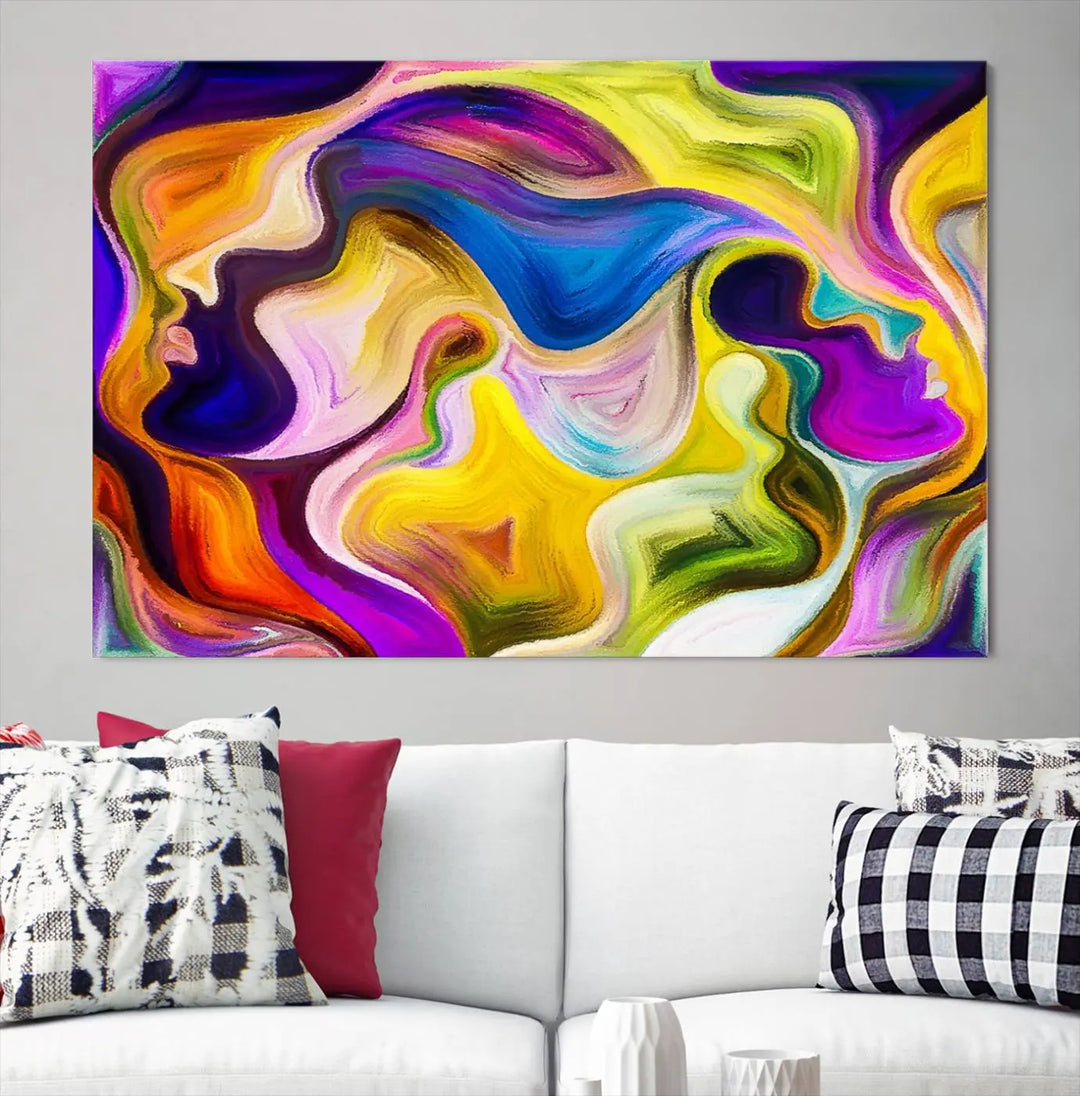 The wall above features the Vibrant Colors Human Figures Wall Art Canvas Print. Each piece showcases abstract multicolored face silhouettes on museum-quality canvas, enhancing both its vibrancy and longevity.