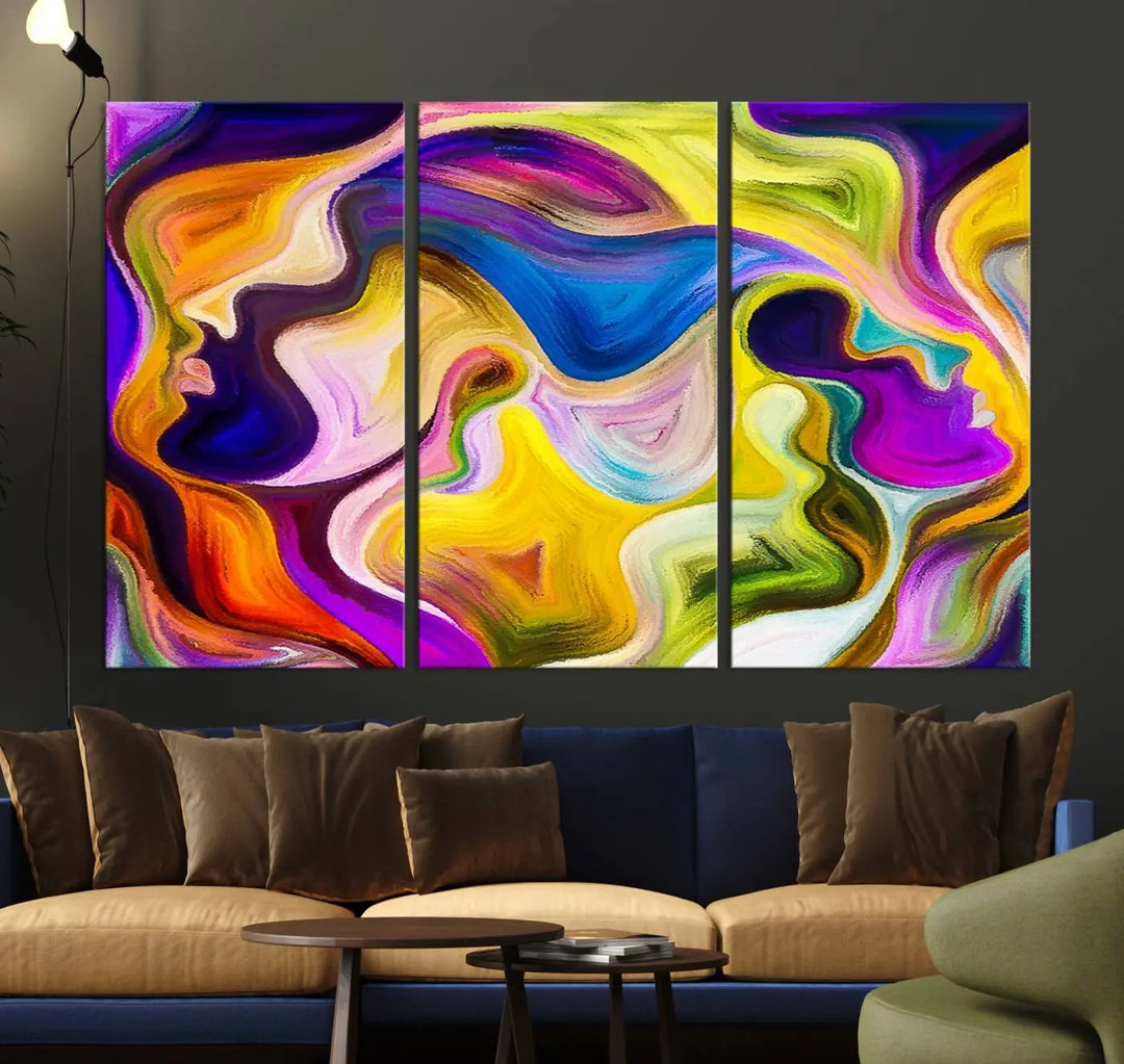 The wall above features the Vibrant Colors Human Figures Wall Art Canvas Print. Each piece showcases abstract multicolored face silhouettes on museum-quality canvas, enhancing both its vibrancy and longevity.