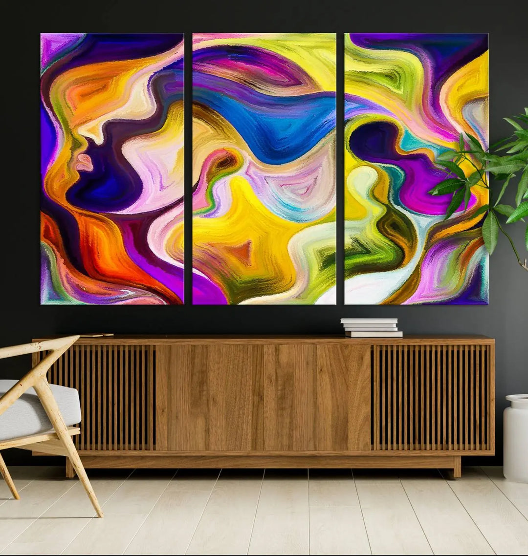 The wall above features the Vibrant Colors Human Figures Wall Art Canvas Print. Each piece showcases abstract multicolored face silhouettes on museum-quality canvas, enhancing both its vibrancy and longevity.