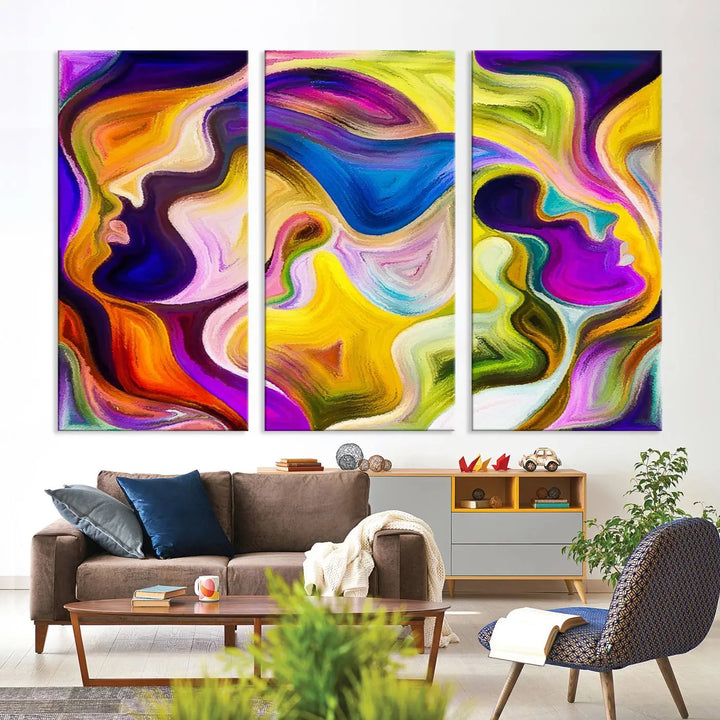 The wall above features the Vibrant Colors Human Figures Wall Art Canvas Print. Each piece showcases abstract multicolored face silhouettes on museum-quality canvas, enhancing both its vibrancy and longevity.