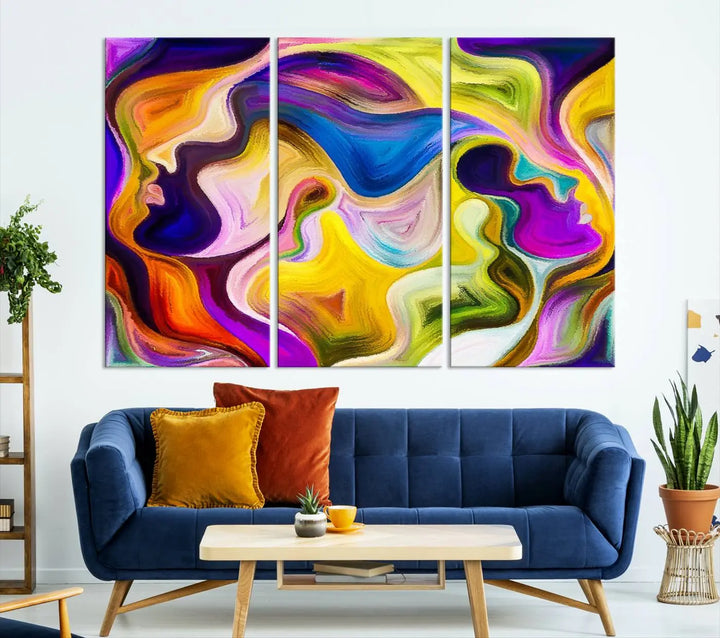 The wall above features the Vibrant Colors Human Figures Wall Art Canvas Print. Each piece showcases abstract multicolored face silhouettes on museum-quality canvas, enhancing both its vibrancy and longevity.