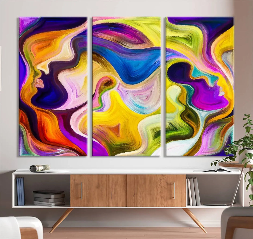 The wall above features the Vibrant Colors Human Figures Wall Art Canvas Print. Each piece showcases abstract multicolored face silhouettes on museum-quality canvas, enhancing both its vibrancy and longevity.