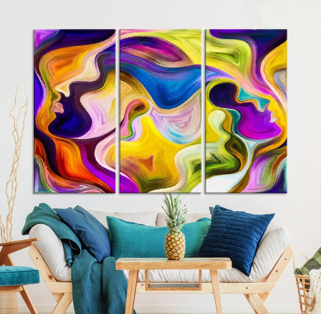 The wall above features the Vibrant Colors Human Figures Wall Art Canvas Print. Each piece showcases abstract multicolored face silhouettes on museum-quality canvas, enhancing both its vibrancy and longevity.