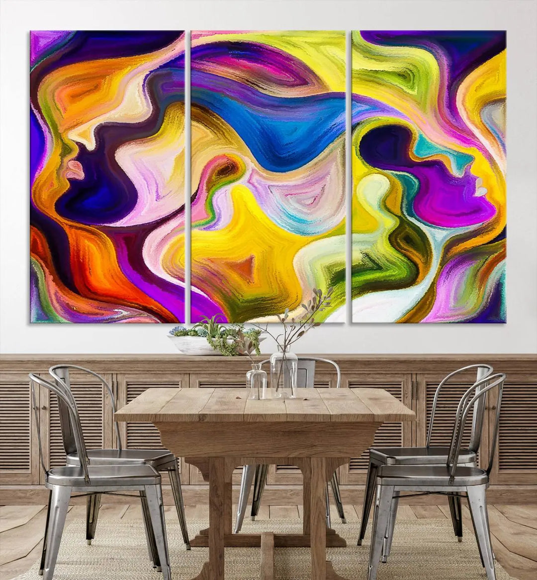 The wall above features the Vibrant Colors Human Figures Wall Art Canvas Print. Each piece showcases abstract multicolored face silhouettes on museum-quality canvas, enhancing both its vibrancy and longevity.