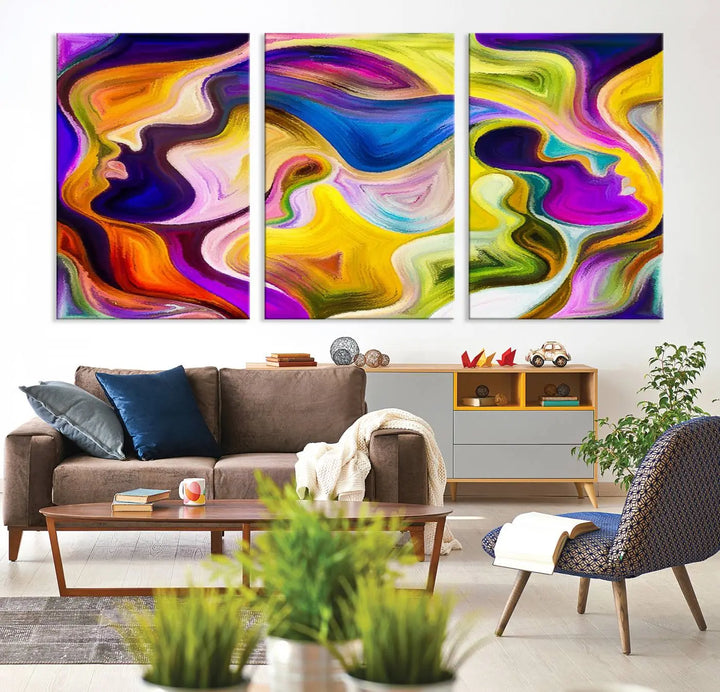 The wall above features the Vibrant Colors Human Figures Wall Art Canvas Print. Each piece showcases abstract multicolored face silhouettes on museum-quality canvas, enhancing both its vibrancy and longevity.