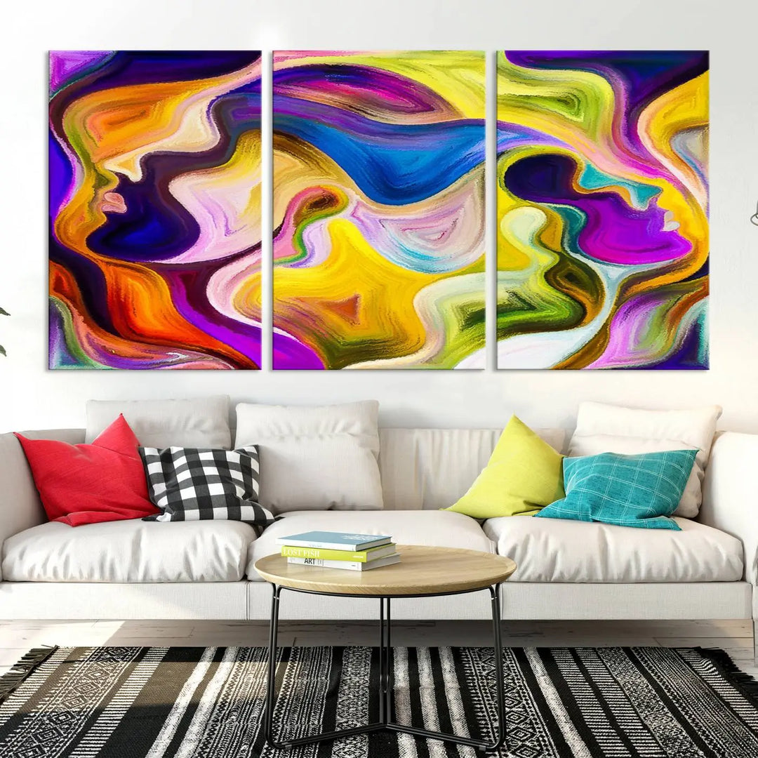 The wall above features the Vibrant Colors Human Figures Wall Art Canvas Print. Each piece showcases abstract multicolored face silhouettes on museum-quality canvas, enhancing both its vibrancy and longevity.