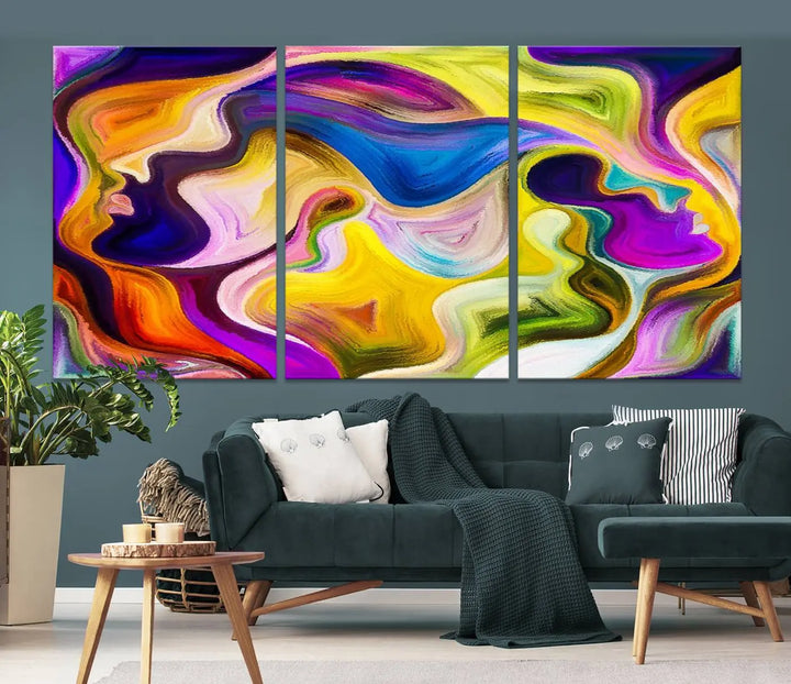 The wall above features the Vibrant Colors Human Figures Wall Art Canvas Print. Each piece showcases abstract multicolored face silhouettes on museum-quality canvas, enhancing both its vibrancy and longevity.