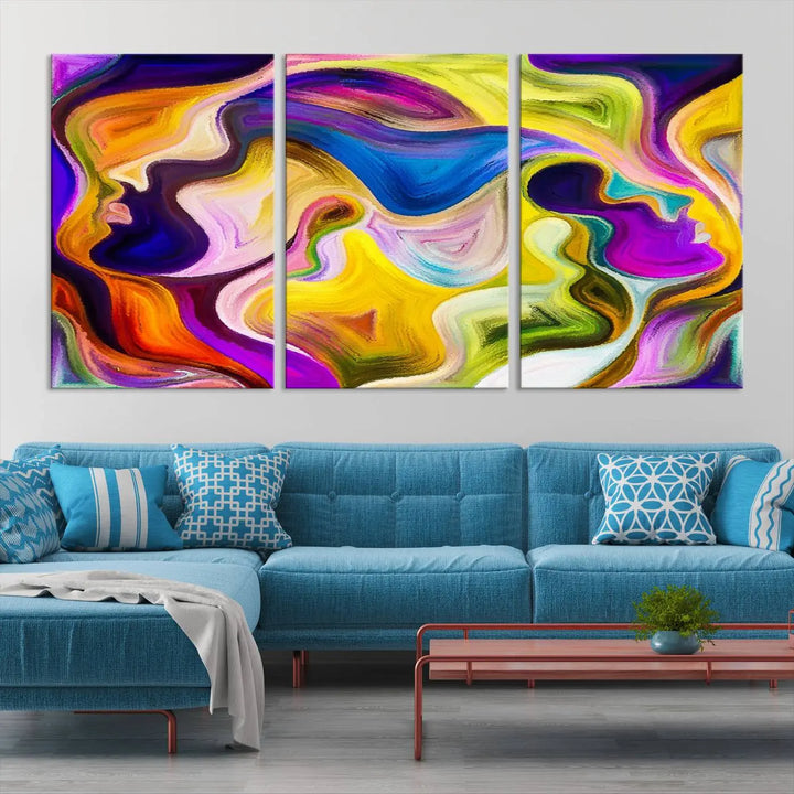 The wall above features the Vibrant Colors Human Figures Wall Art Canvas Print. Each piece showcases abstract multicolored face silhouettes on museum-quality canvas, enhancing both its vibrancy and longevity.