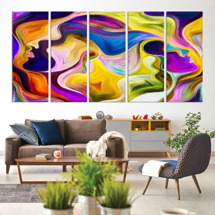 The wall above features the Vibrant Colors Human Figures Wall Art Canvas Print. Each piece showcases abstract multicolored face silhouettes on museum-quality canvas, enhancing both its vibrancy and longevity.