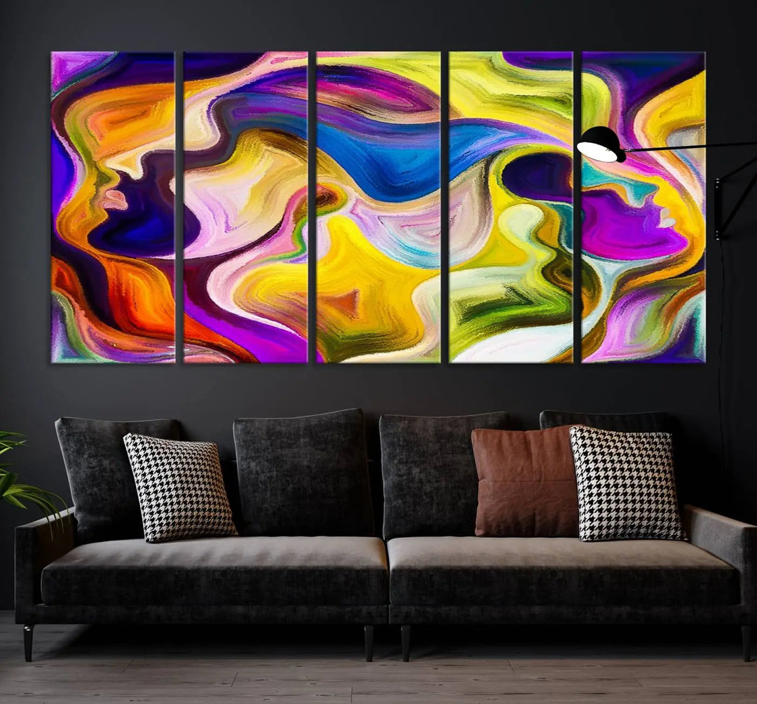 The wall above features the Vibrant Colors Human Figures Wall Art Canvas Print. Each piece showcases abstract multicolored face silhouettes on museum-quality canvas, enhancing both its vibrancy and longevity.