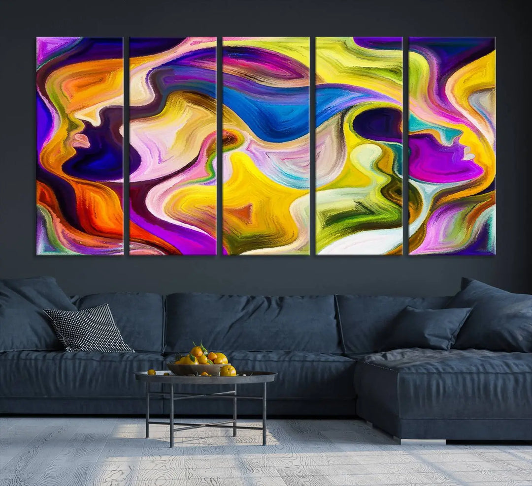 The wall above features the Vibrant Colors Human Figures Wall Art Canvas Print. Each piece showcases abstract multicolored face silhouettes on museum-quality canvas, enhancing both its vibrancy and longevity.