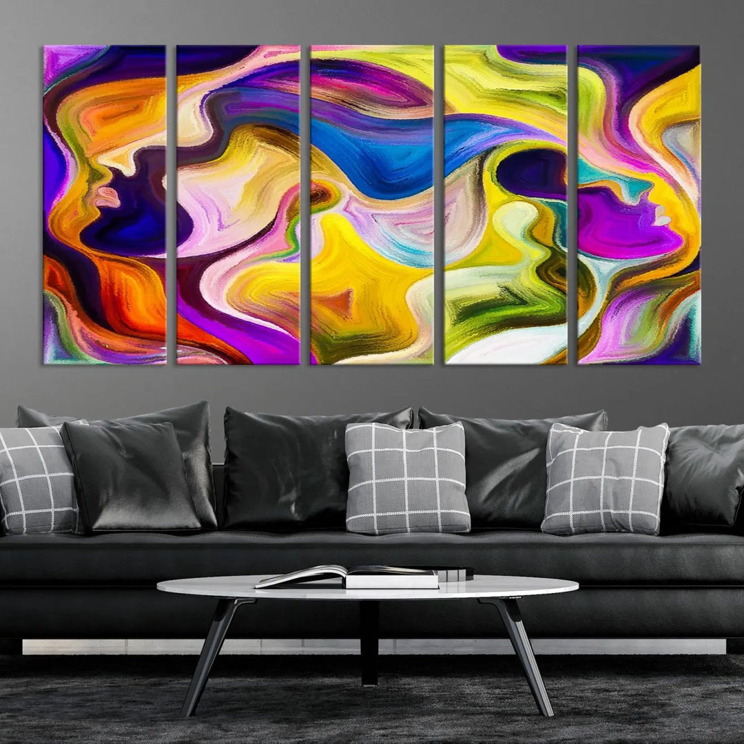 The wall above features the Vibrant Colors Human Figures Wall Art Canvas Print. Each piece showcases abstract multicolored face silhouettes on museum-quality canvas, enhancing both its vibrancy and longevity.