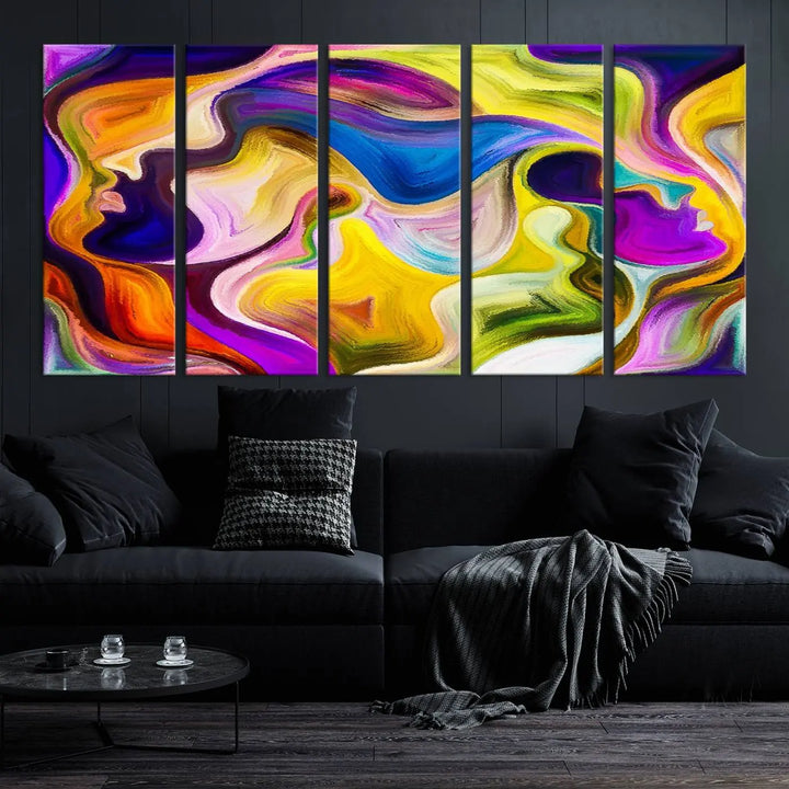 The wall above features the Vibrant Colors Human Figures Wall Art Canvas Print. Each piece showcases abstract multicolored face silhouettes on museum-quality canvas, enhancing both its vibrancy and longevity.