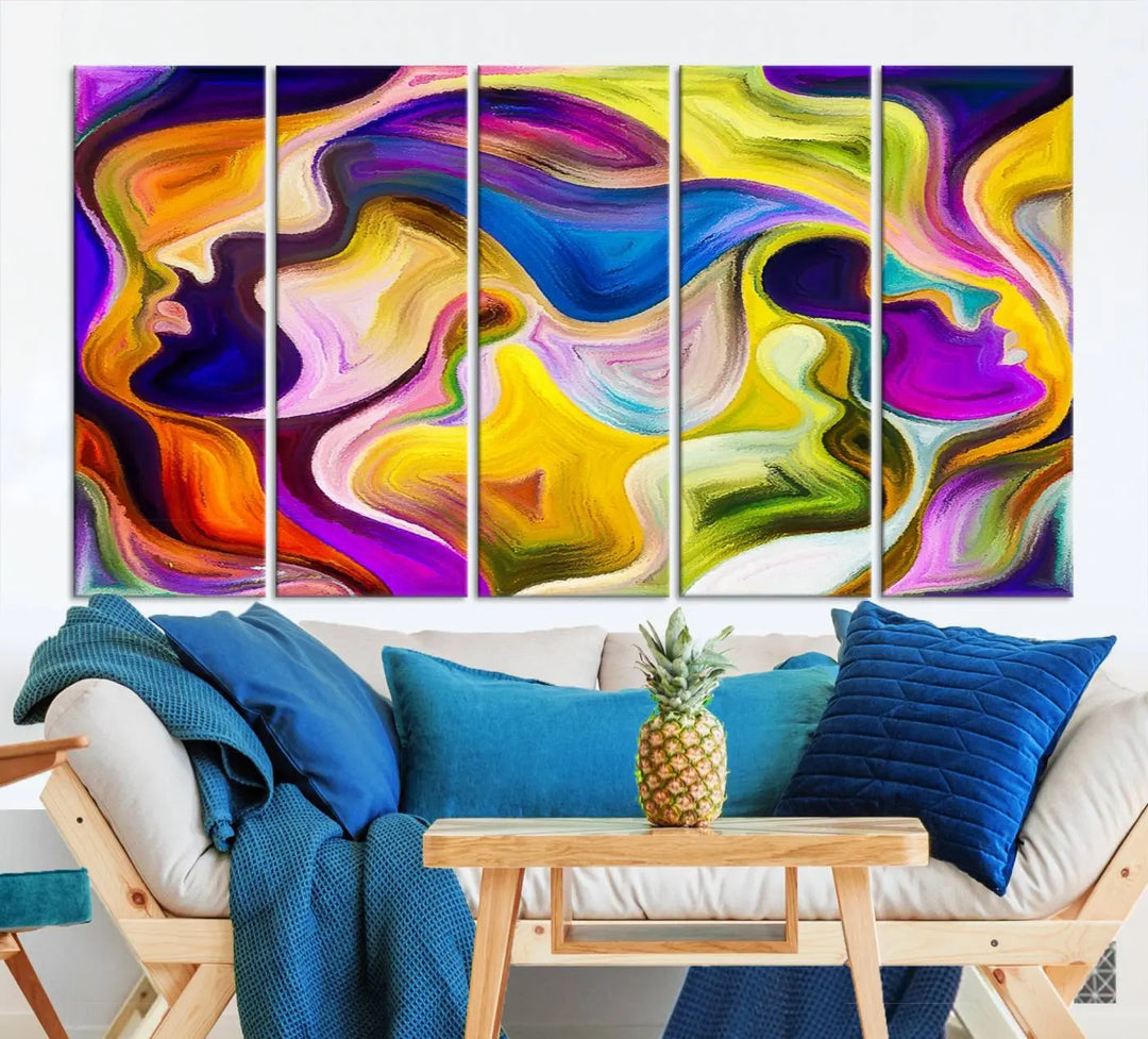 The wall above features the Vibrant Colors Human Figures Wall Art Canvas Print. Each piece showcases abstract multicolored face silhouettes on museum-quality canvas, enhancing both its vibrancy and longevity.