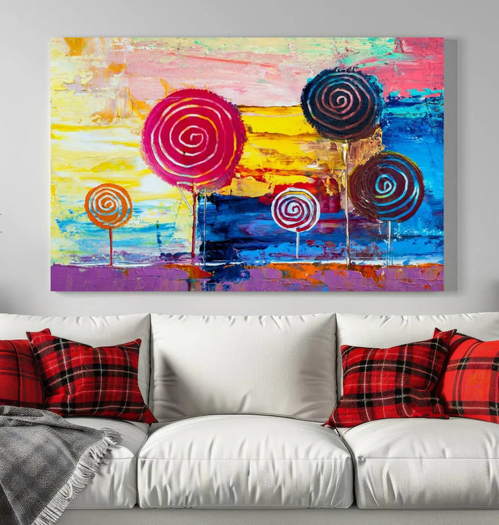 The Vibrant Lollipops Wall Art Canvas Print features a colorful abstract design of spiral trees set against a sunset background. This elegantly gallery-wrapped piece comes with a UV-protective coating, creating an impressive centerpiece in the room.