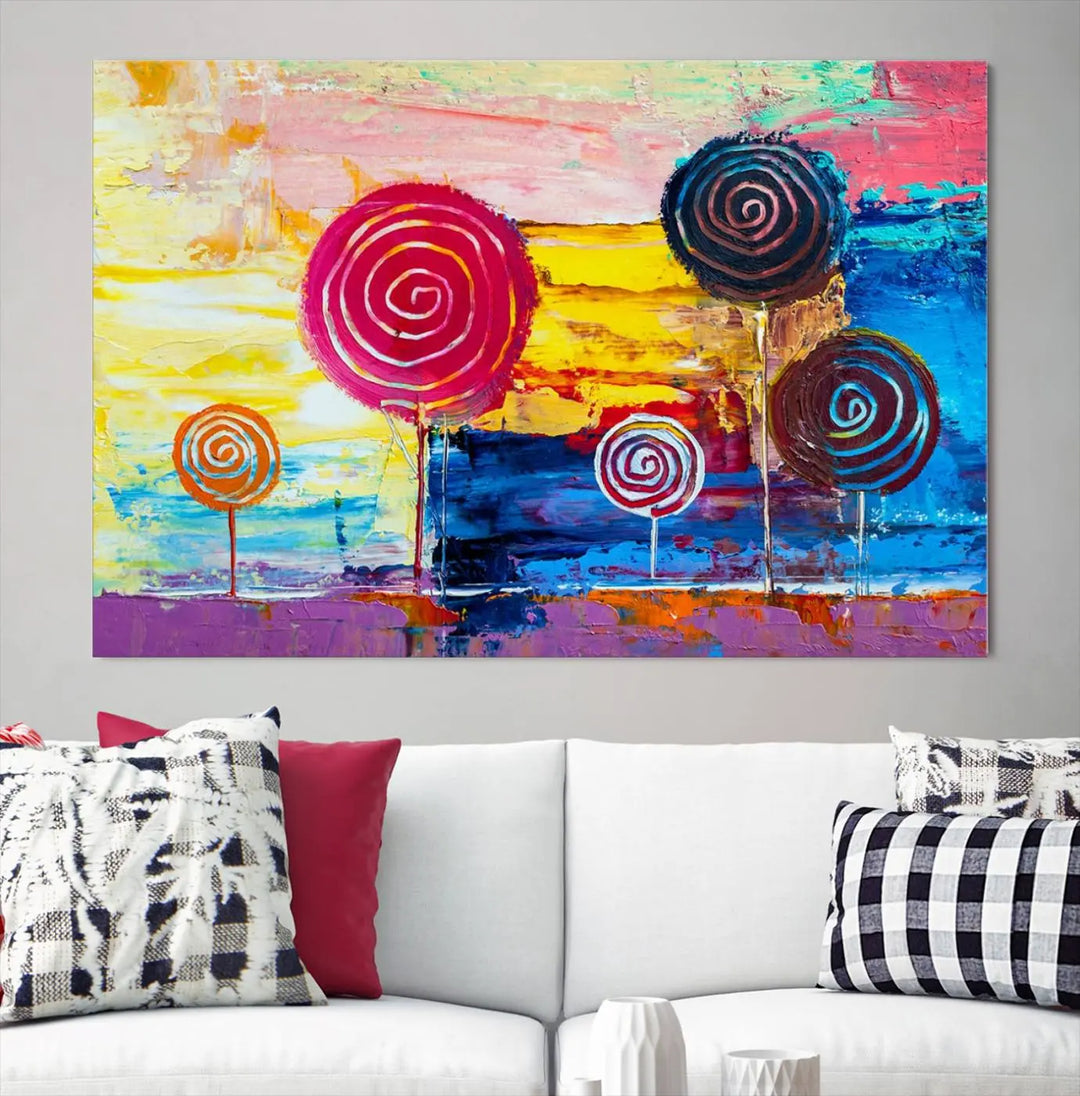 The Vibrant Lollipops Wall Art Canvas Print features a colorful abstract design of spiral trees set against a sunset background. This elegantly gallery-wrapped piece comes with a UV-protective coating, creating an impressive centerpiece in the room.