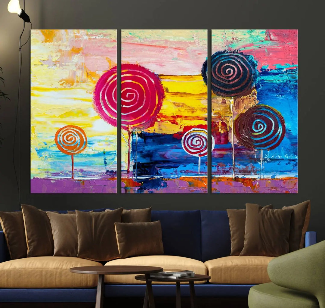 The Vibrant Lollipops Wall Art Canvas Print features a colorful abstract design of spiral trees set against a sunset background. This elegantly gallery-wrapped piece comes with a UV-protective coating, creating an impressive centerpiece in the room.