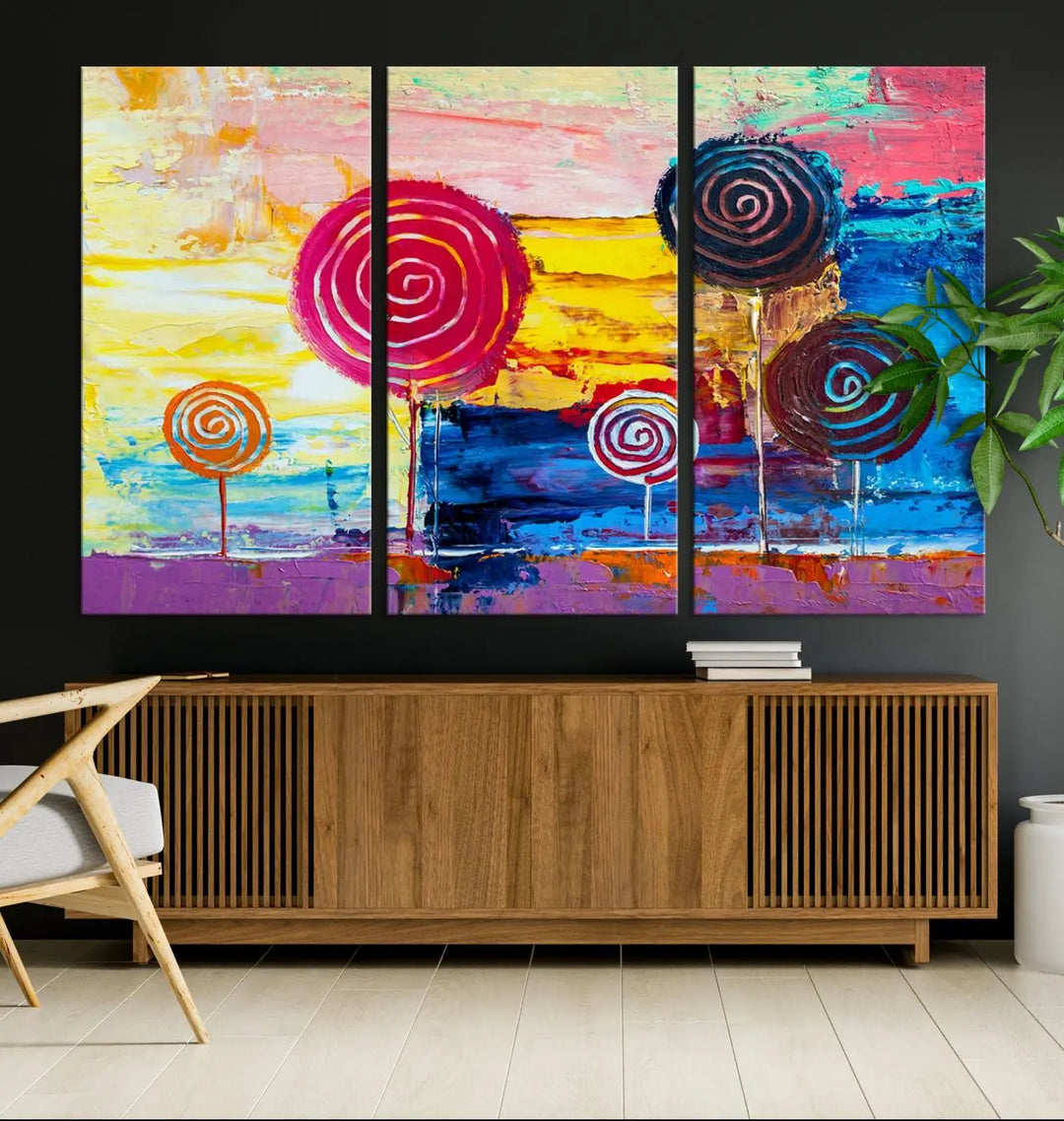 The Vibrant Lollipops Wall Art Canvas Print features a colorful abstract design of spiral trees set against a sunset background. This elegantly gallery-wrapped piece comes with a UV-protective coating, creating an impressive centerpiece in the room.