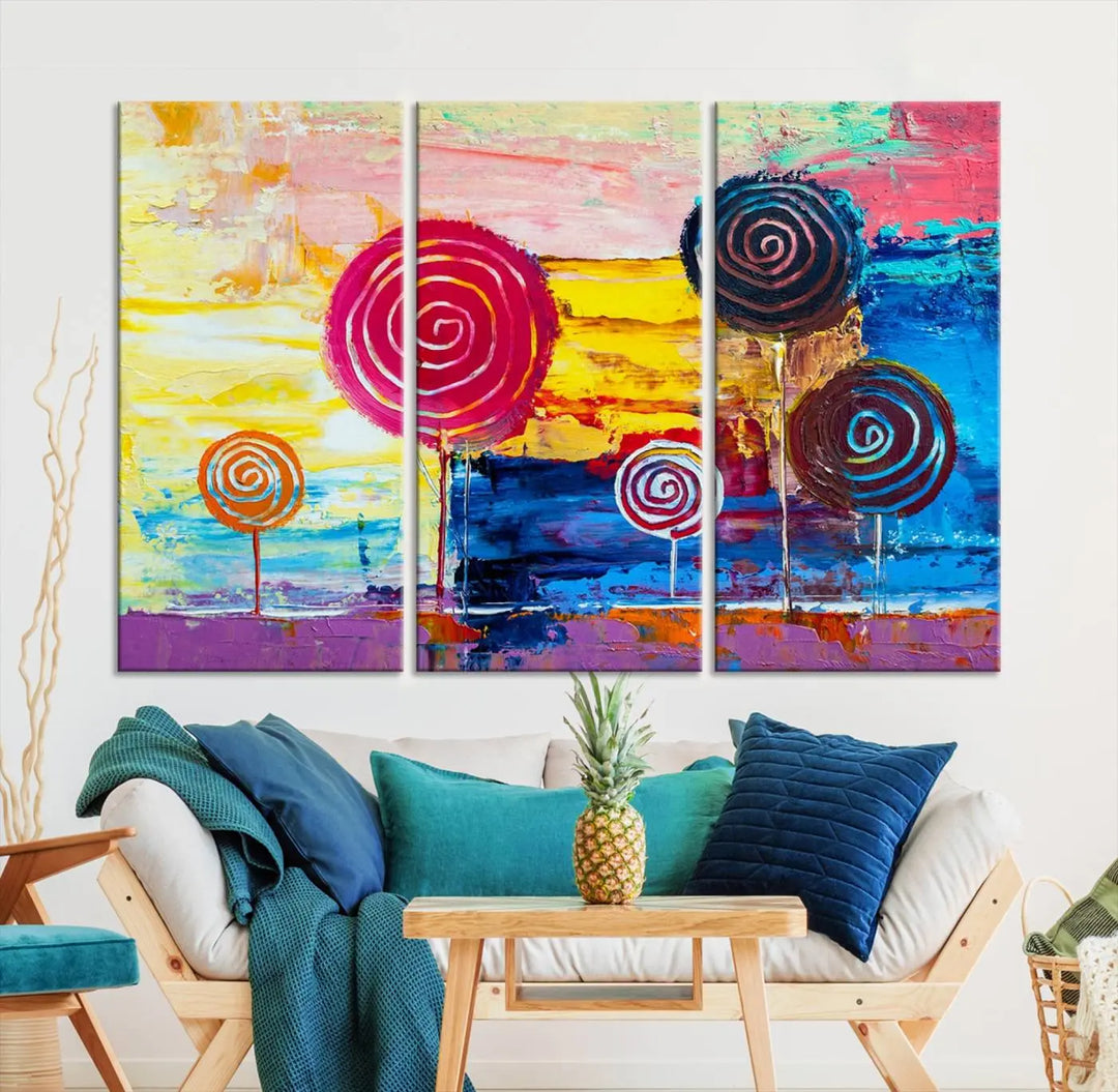 The Vibrant Lollipops Wall Art Canvas Print features a colorful abstract design of spiral trees set against a sunset background. This elegantly gallery-wrapped piece comes with a UV-protective coating, creating an impressive centerpiece in the room.