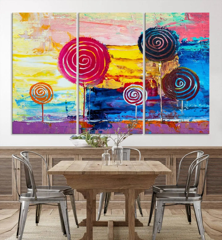 The Vibrant Lollipops Wall Art Canvas Print features a colorful abstract design of spiral trees set against a sunset background. This elegantly gallery-wrapped piece comes with a UV-protective coating, creating an impressive centerpiece in the room.