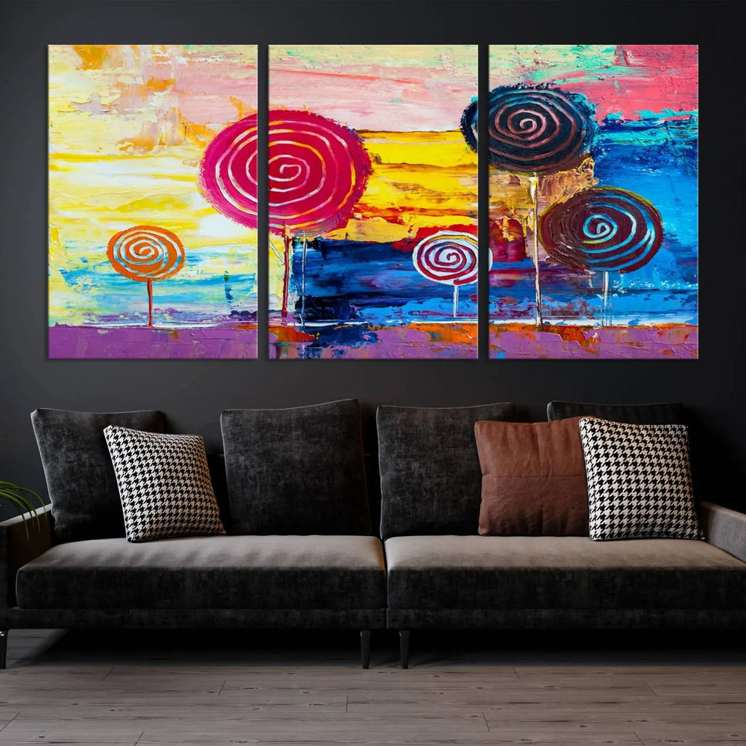 The Vibrant Lollipops Wall Art Canvas Print features a colorful abstract design of spiral trees set against a sunset background. This elegantly gallery-wrapped piece comes with a UV-protective coating, creating an impressive centerpiece in the room.