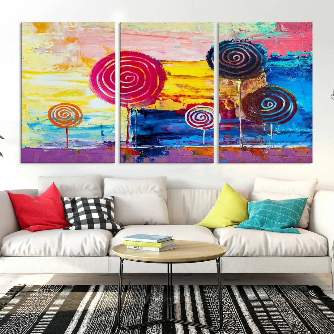 The Vibrant Lollipops Wall Art Canvas Print features a colorful abstract design of spiral trees set against a sunset background. This elegantly gallery-wrapped piece comes with a UV-protective coating, creating an impressive centerpiece in the room.