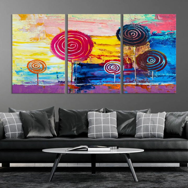 The Vibrant Lollipops Wall Art Canvas Print features a colorful abstract design of spiral trees set against a sunset background. This elegantly gallery-wrapped piece comes with a UV-protective coating, creating an impressive centerpiece in the room.