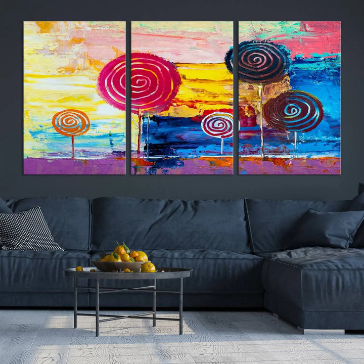 The Vibrant Lollipops Wall Art Canvas Print features a colorful abstract design of spiral trees set against a sunset background. This elegantly gallery-wrapped piece comes with a UV-protective coating, creating an impressive centerpiece in the room.