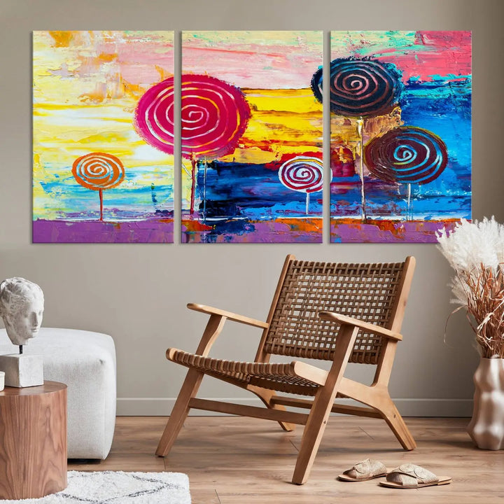 The Vibrant Lollipops Wall Art Canvas Print features a colorful abstract design of spiral trees set against a sunset background. This elegantly gallery-wrapped piece comes with a UV-protective coating, creating an impressive centerpiece in the room.