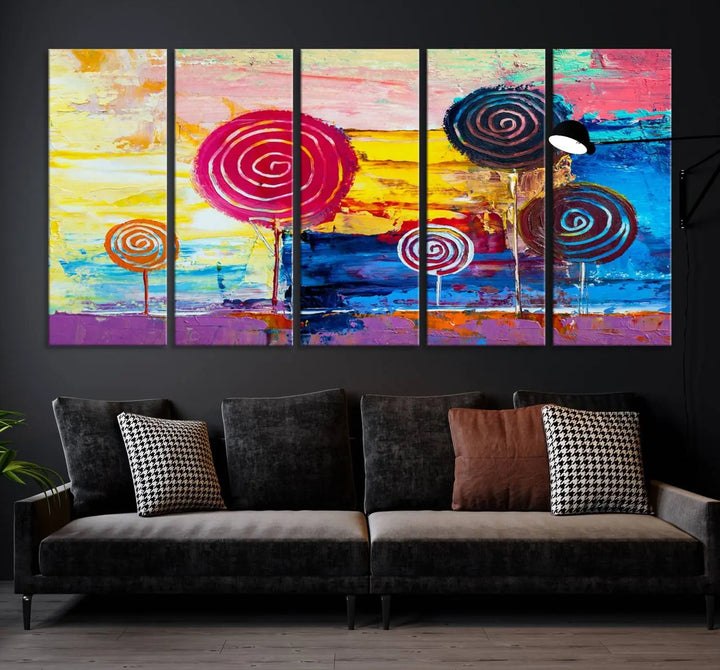 The Vibrant Lollipops Wall Art Canvas Print features a colorful abstract design of spiral trees set against a sunset background. This elegantly gallery-wrapped piece comes with a UV-protective coating, creating an impressive centerpiece in the room.