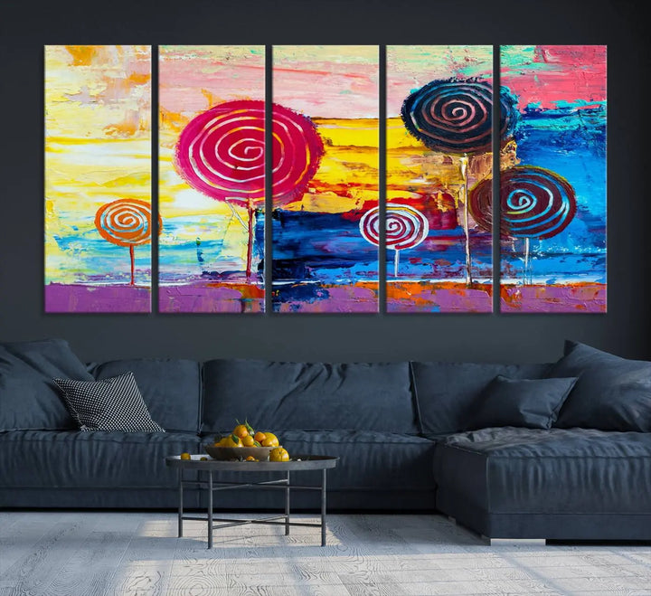 The Vibrant Lollipops Wall Art Canvas Print features a colorful abstract design of spiral trees set against a sunset background. This elegantly gallery-wrapped piece comes with a UV-protective coating, creating an impressive centerpiece in the room.