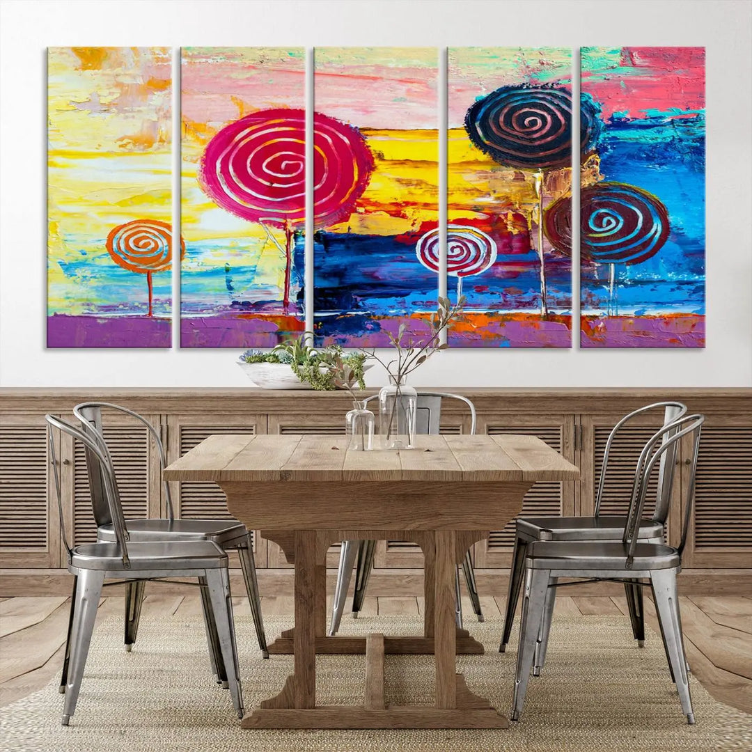 The Vibrant Lollipops Wall Art Canvas Print features a colorful abstract design of spiral trees set against a sunset background. This elegantly gallery-wrapped piece comes with a UV-protective coating, creating an impressive centerpiece in the room.