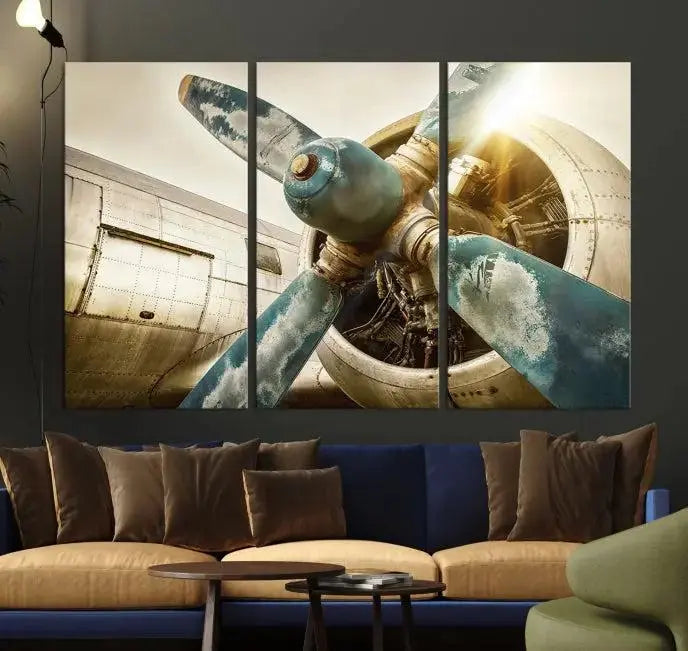 The Vintage Airplane Canvas Print, featuring a triptych design with an airplane propeller on museum-quality canvases with UV-protective coating, is displayed in a cozy living room.