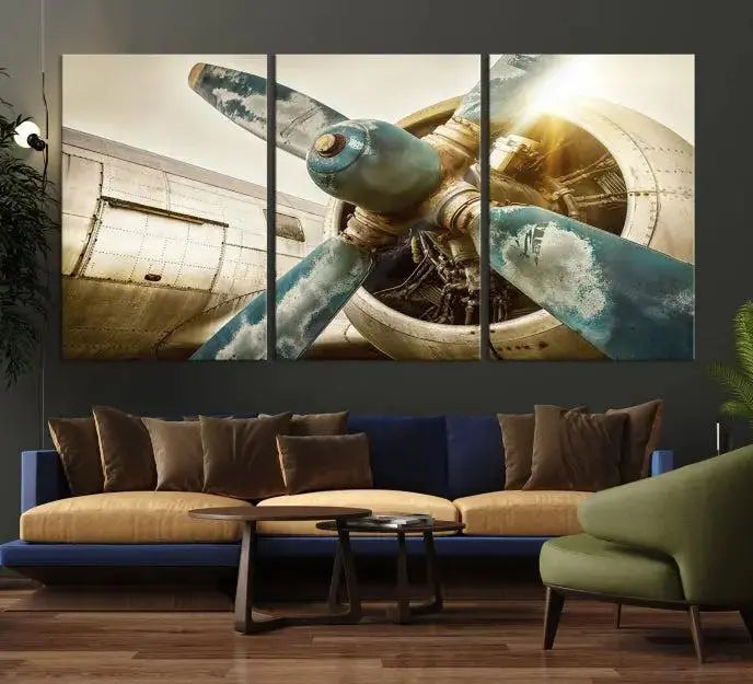 The Vintage Airplane Canvas Print, featuring a triptych design with an airplane propeller on museum-quality canvases with UV-protective coating, is displayed in a cozy living room.