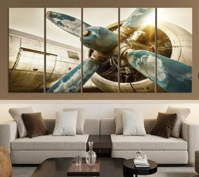 The Vintage Airplane Canvas Print, featuring a triptych design with an airplane propeller on museum-quality canvases with UV-protective coating, is displayed in a cozy living room.