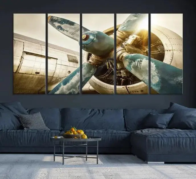 The Vintage Airplane Canvas Print, featuring a triptych design with an airplane propeller on museum-quality canvases with UV-protective coating, is displayed in a cozy living room.