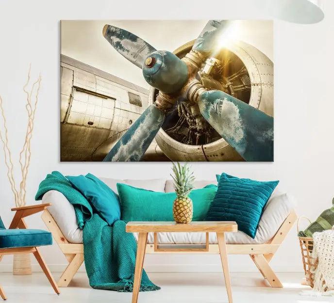 The Vintage Airplane Canvas Print, featuring a triptych design with an airplane propeller on museum-quality canvases with UV-protective coating, is displayed in a cozy living room.