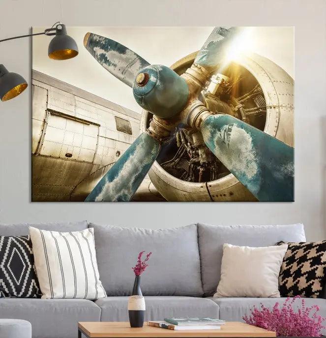 The Vintage Airplane Canvas Print, featuring a triptych design with an airplane propeller on museum-quality canvases with UV-protective coating, is displayed in a cozy living room.