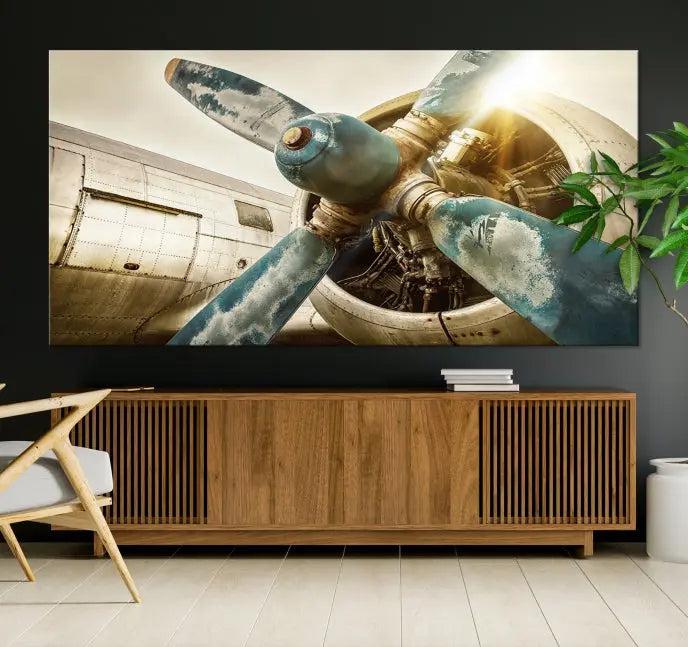 The Vintage Airplane Canvas Print, featuring a triptych design with an airplane propeller on museum-quality canvases with UV-protective coating, is displayed in a cozy living room.