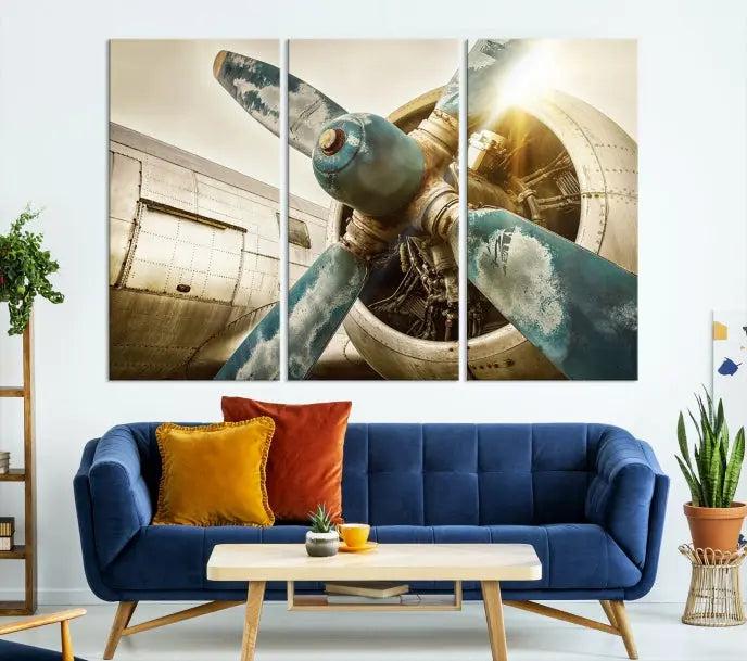 The Vintage Airplane Canvas Print, featuring a triptych design with an airplane propeller on museum-quality canvases with UV-protective coating, is displayed in a cozy living room.