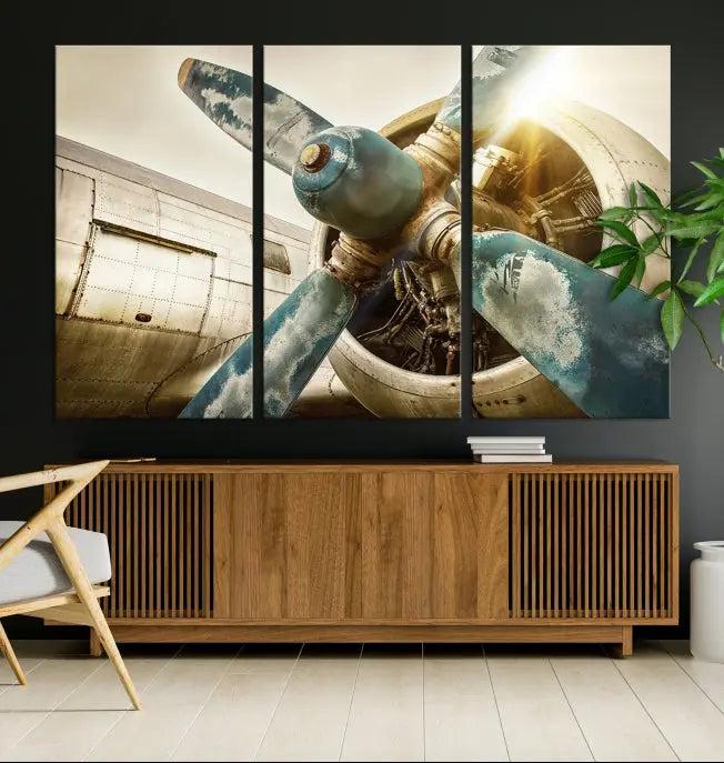 The Vintage Airplane Canvas Print, featuring a triptych design with an airplane propeller on museum-quality canvases with UV-protective coating, is displayed in a cozy living room.