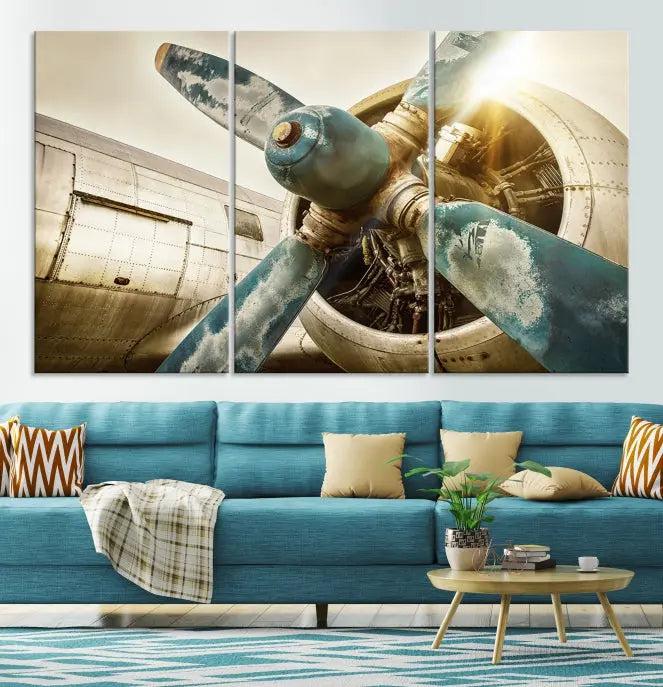 The Vintage Airplane Canvas Print, featuring a triptych design with an airplane propeller on museum-quality canvases with UV-protective coating, is displayed in a cozy living room.