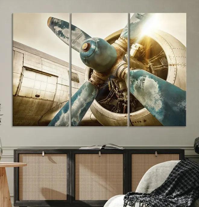 The Vintage Airplane Canvas Print, featuring a triptych design with an airplane propeller on museum-quality canvases with UV-protective coating, is displayed in a cozy living room.