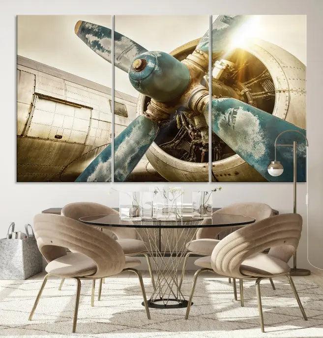 The Vintage Airplane Canvas Print, featuring a triptych design with an airplane propeller on museum-quality canvases with UV-protective coating, is displayed in a cozy living room.