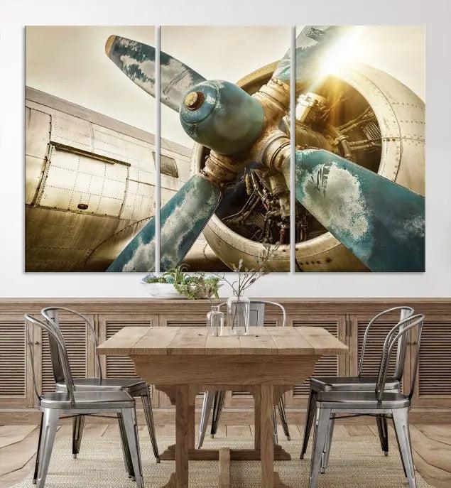 The Vintage Airplane Canvas Print, featuring a triptych design with an airplane propeller on museum-quality canvases with UV-protective coating, is displayed in a cozy living room.